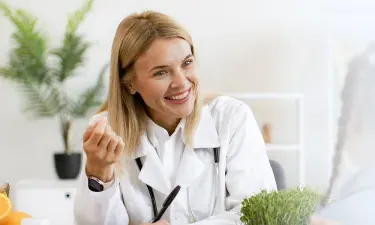 Rhode Island family nurse practitioner smiling with pediatric patient during appointment